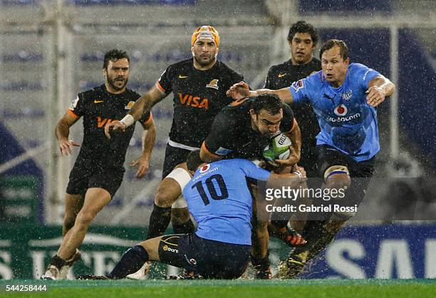 Agustin Creevy of Jaguares is tackled by Francois Brummer of Bulls during a match between Argentina and Bulls as part of Super Rugby Rd 15 at Jose...