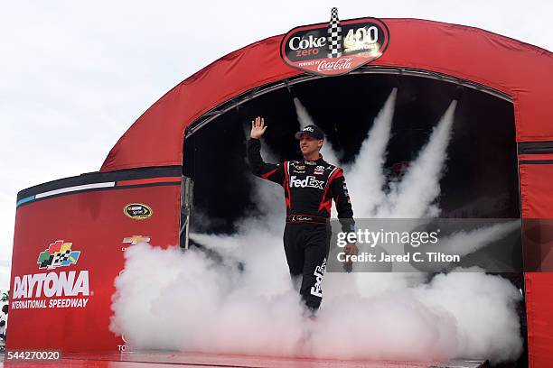 Denny Hamlin, driver of the FedEx Toyota, is introduced prior to the start of the NASCAR Sprint Cup Series Coke Zero 400 Powered By Coca-Cola at...
