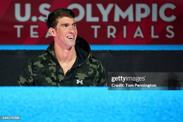 Michael Phelps of the United States participates in the medal ceremony for the Men's 100 Meter Butterfly during Day Seven of the 2016 U.S. Olympic...