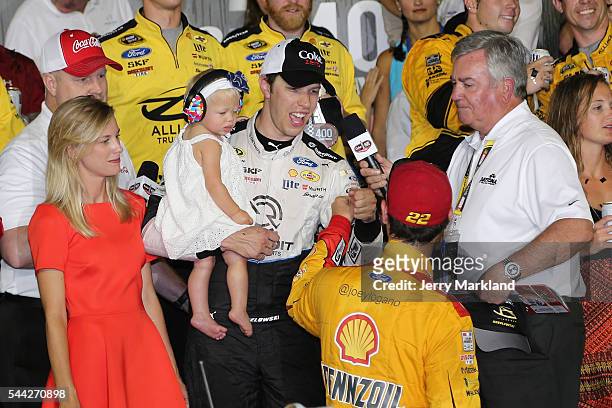 Brad Keselowski, driver of the Detroit Genuine Parts Ford, is congratulated by teammate Joey Logano, driver of the Shell Pennzoil Ford, in Victory...