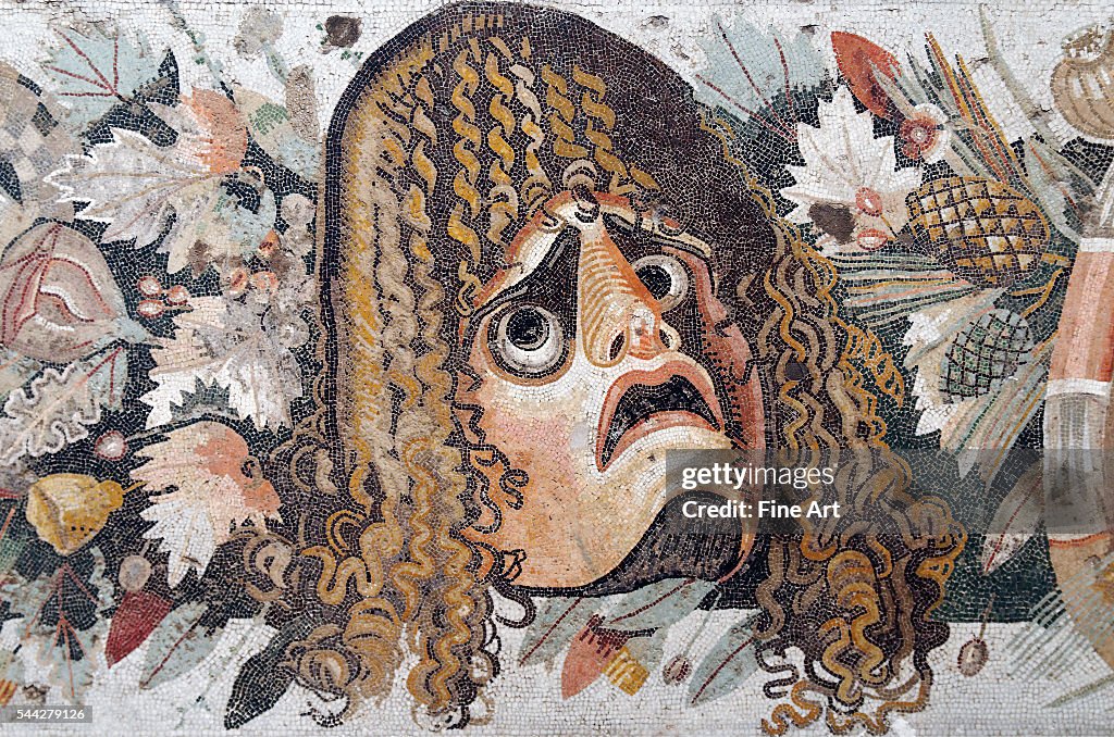 Detail of Roman mosaic depicting tragic mask with leaves and fruit