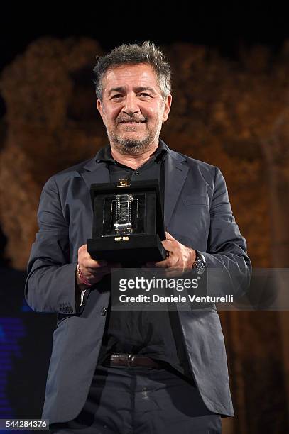 Pietro Valsecchi receives Nastro D'Argento on stage during the Nastri D'Argento Awards Ceremony on July 2, 2016 in Taormina, Italy.