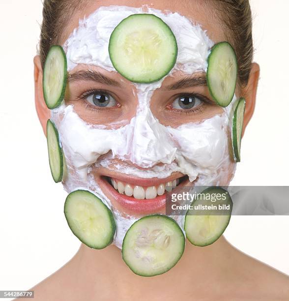 Schoenheitspflege, Gesichtpflege, Hautpflege, Gurkenmaske: Frau mit Gurkenscheiben und Quark auf dem Gesicht