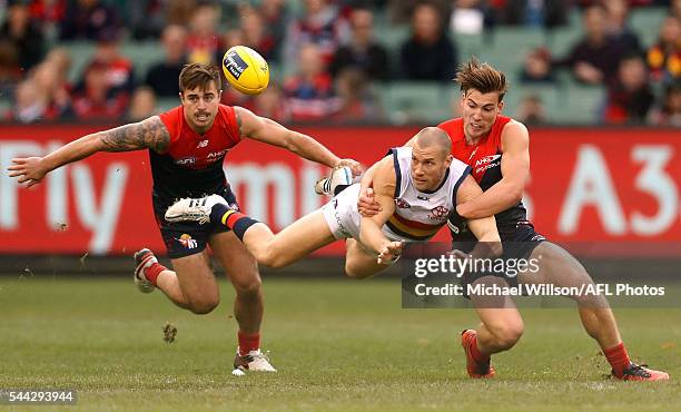 Scott Thompson of the Crows is tackled by Jack Viney of the Demons during the 2016 AFL Round 15 match between the Melbourne Demons and the Adelaide...