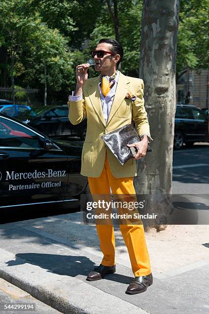 Fashion Consultant Antonio Nieto wears a Saint Lauren jacket, Etro trousers, bag and sunglasses, Ferragamo shoes and Hermes scarf on day 2 of Paris...