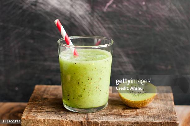 kiwi smoothie on a wooden background with paper straw - new zealand culture stock pictures, royalty-free photos & images