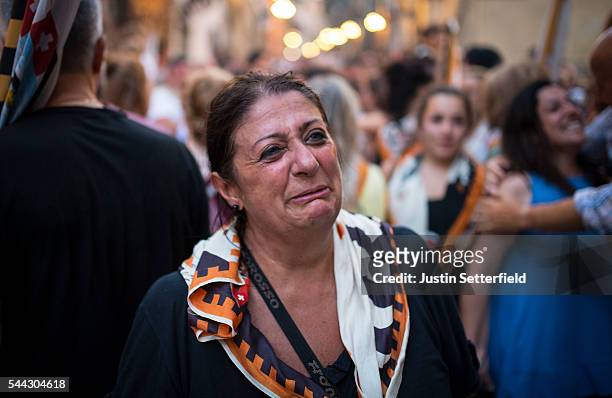 Member of the 'Contrada of Lupa' celebrates winning the historical Italian horse race of the Palio Di Siena on July 02, 2016 in Siena, Italy. The...