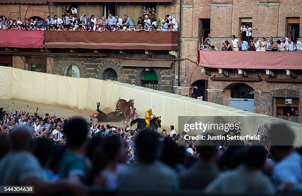 Horses fall on the bend during the historical Italian horse race of the Palio Di Siena on July 02, 2016 in Siena, Italy. The Palio di Siena, known...