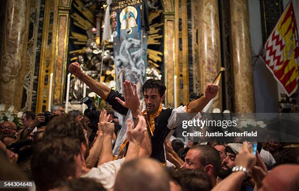 The jockey, Jonatan Bartoletti aka 'Scompiglio' of the 'Contrada of Lupa' is carried through his contradas church after winning the historical...