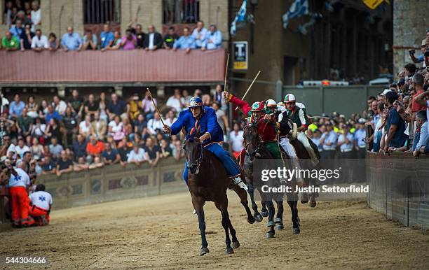 The jockey of the 'Contrada of Nicchio' leads the field during the historical Italian horse race of the Palio Di Siena on July 02, 2016 in Siena,...