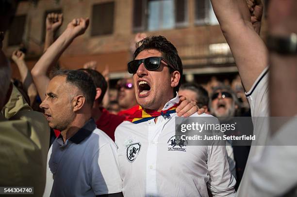 Spectator supports his contrada during a trial race of the historical Italian horse race of the Palio Di Siena on June 30, 2016 in Siena, Italy. The...