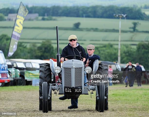The owner of a vintage tractor drive to their position at the annual Duncombe Park Steam Fair on July 3, 2016 in Helmsley, England. Held in the...