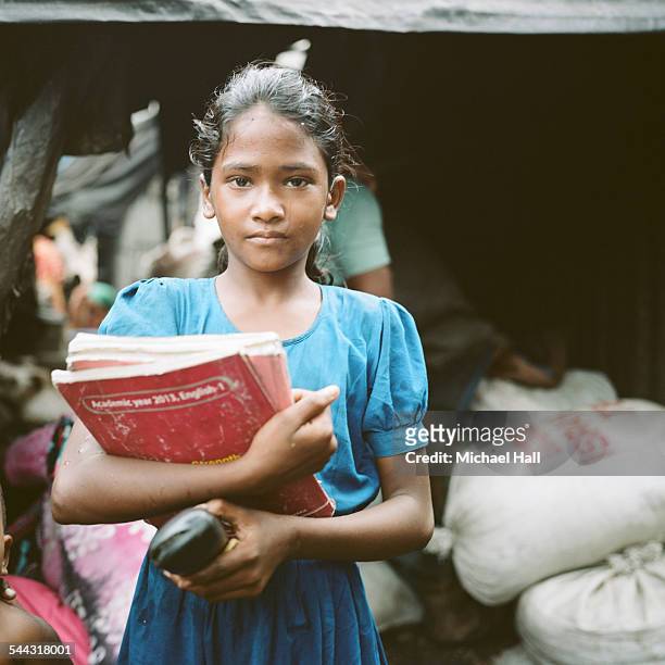 young girl from slum with school books - bangladeshi child stock pictures, royalty-free photos & images