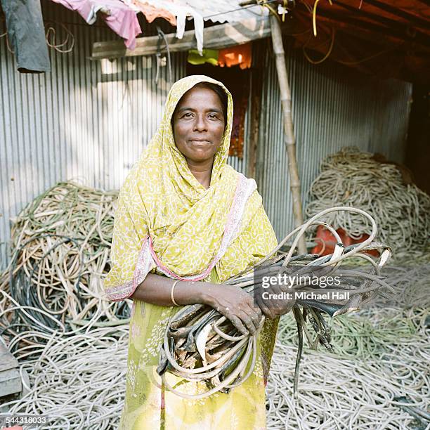 woman striping copper from cables - bangladeshi woman stock pictures, royalty-free photos & images