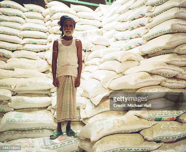 old man in rice storage warehouse - food security stock pictures, royalty-free photos & images