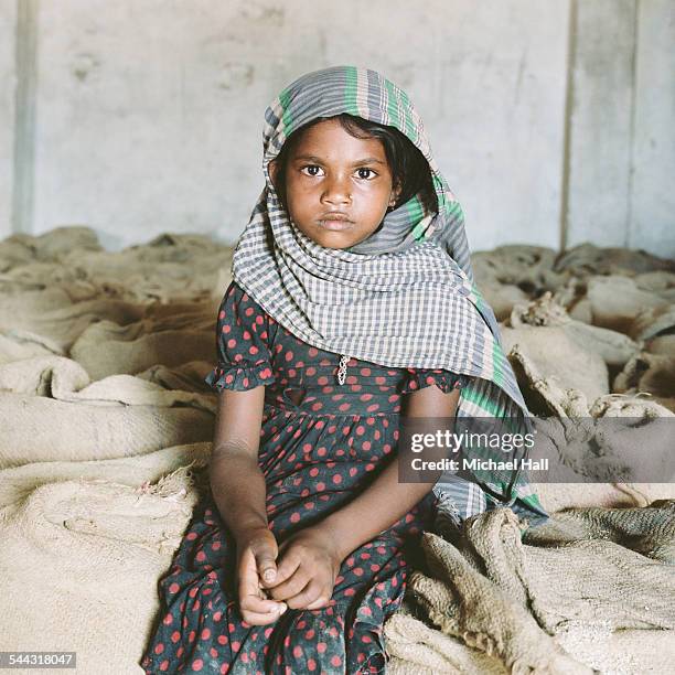 girl in rice store - bangladeshi child stock pictures, royalty-free photos & images