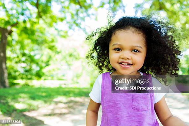 beautiful little girl in the park - cute girl portrait stock pictures, royalty-free photos & images