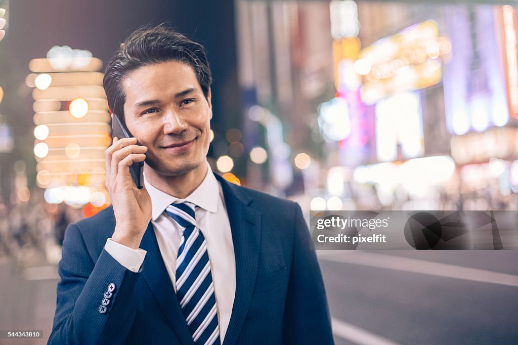 Businessman talking on the phone at night