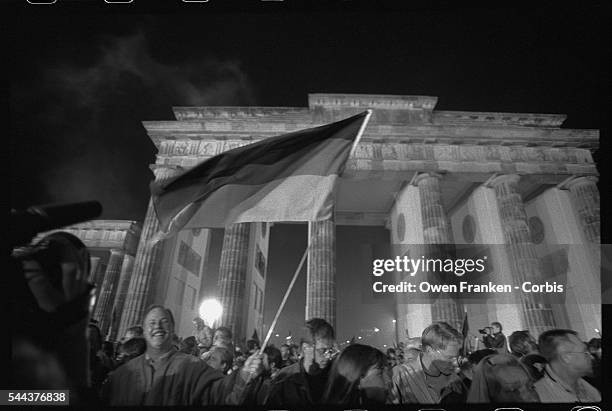 Crowds converge on the Brandenburg Gate at midnight October 2-3 the moment that the official reunification of East and West Germany took effect....