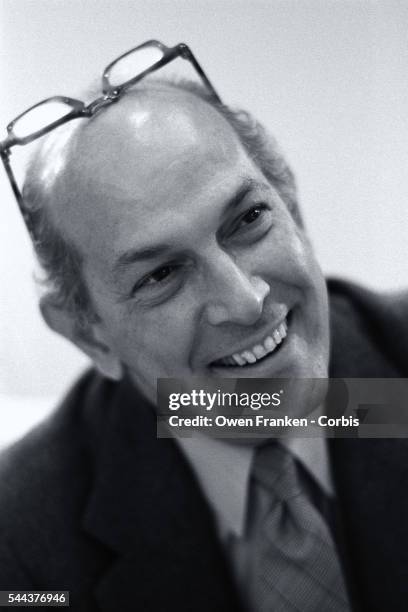 Portrait of Oscar de La Renta with his glasses pushed on top of his head.