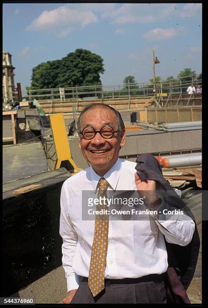 Architect I.M. Pei stands in front of the construction site for the Louvre pyramid. He designed the glass and metal pyramid to serve as an entrance...