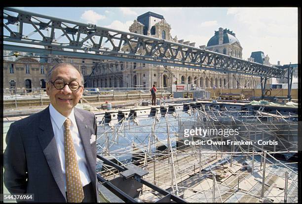 Architect I.M. Pei stands in front of the construction site for the Louvre's inverted pyramid. He designed the glass and metal pyramids to serve as...