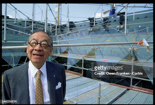 Architect I.M. Pei stands inside of the construction site for the Louvre's inverted pyramid. He designed the glass and metal pyramids to serve as an...