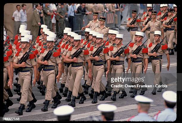 Members of the Foreign Legion march in uniform down the Champs-Elysees for the French bicentennial. They carry machine guns and walk in a Defile...