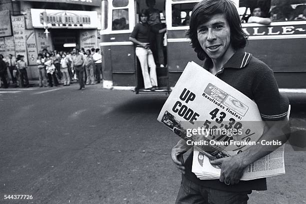 Man sells newspapers reporting the results of the 1973 legislative elections in Chile. This was the last free election in Chile before the Pinochet...