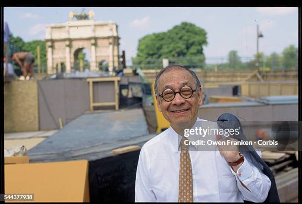 Architect I.M. Pei stands in front of the construction site for the Louvre pyramid. He designed the glass and metal pyramid to serve as an entrance...