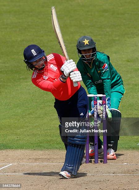 Tasmin Beaumont of England scores runs as Sidra Nawaz of Pakistan looks on during the 1st Natwest International T20 played between England Women and...