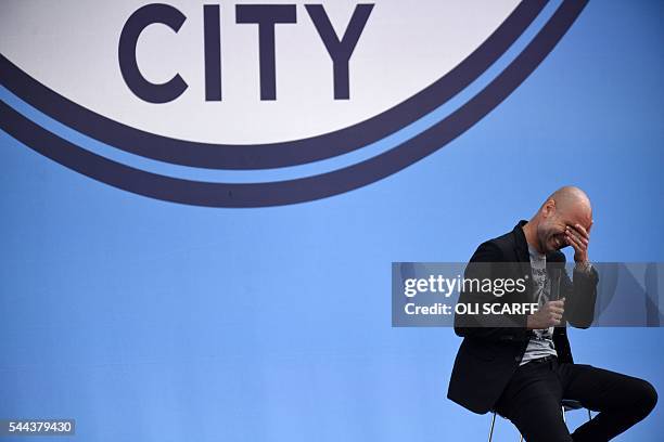 Spanish football manager Pep Guardiola gestures as he speaks to Manchester City fans as he is officially unveiled as the club's new manager at the...