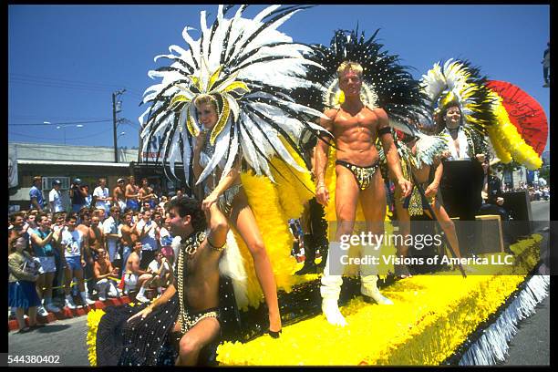 Men in leather bikinis ride a float with a woman dressed as a Las Vegas showgirl at the 19th Annual Gay and Lesbian Pride Parade in Hollywood,...