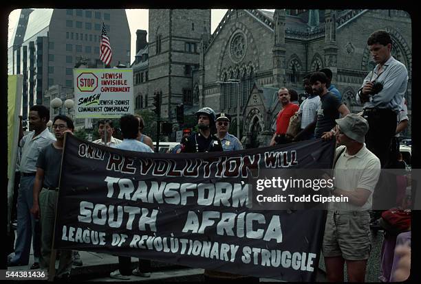 Members of the League of Revolutionary Struggle hold a banner supporting revolution in the transformation of South Africa during a demonstration.