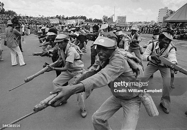 During a demonstration against imperialism, a group of soldiers goes through the motions of bayonetting with woodblocks in place of guns.