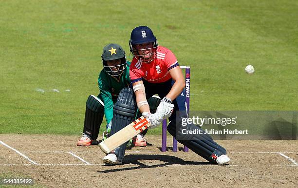 Lauren Winfield of England scores runs as Sidra Nawaz of Pakistan looks on during the 1st Natwest International T20 played between England Women and...