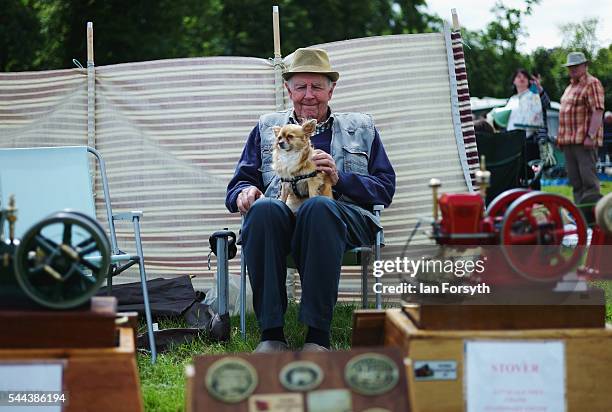 Man sits with his display of miniature engines at a display during the annual Duncombe Park Steam Fair on July 3, 2016 in Helmsley, England. Held in...