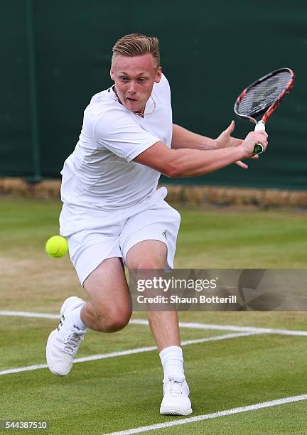 Finn Bass of Great britain plays a backhand during the Boy's singles first round match against Marvin Moeller of Germany on Middle Sunday of the...