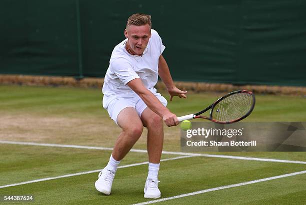 Finn Bass of Great britain plays a backhand during the Boy's singles first round match against Marvin Moeller of Germany on Middle Sunday of the...