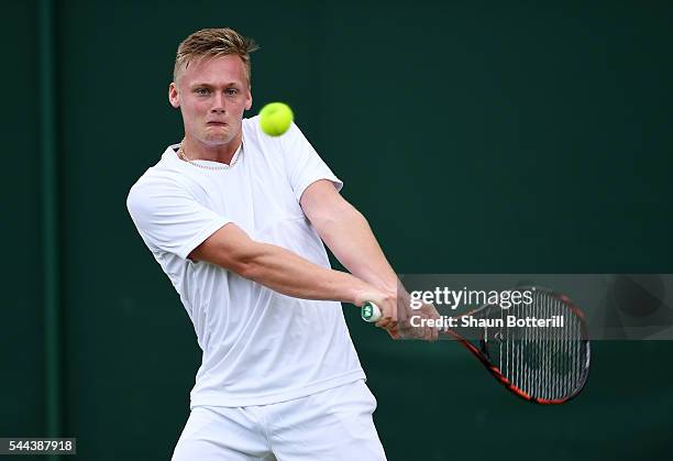 Finn Bass of Great britain plays a backhand during the Boy's singles first round match against Marvin Moeller of Germany on Middle Sunday of the...