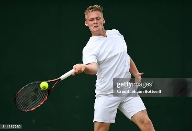 Finn Bass of Great britain plays a backhand during the Boy's singles first round match against Marvin Moeller of Germany on Middle Sunday of the...