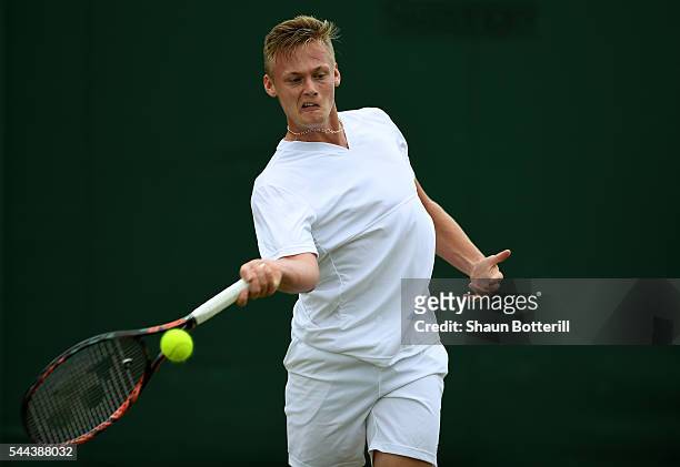 Finn Bass of Great Britain plays a forehand during the Boy's singles first round match against Marvin Moeller of Germany on Middle Sunday of the...