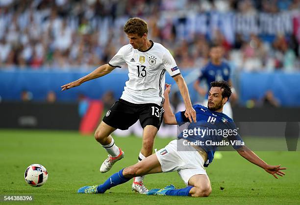 Marco Parolo of Italy and Thomas Muller of Germany compete for the ball during the UEFA Euro 2016 quarter final match between Germany and Italy at...