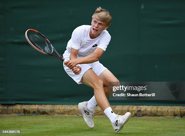 Marvin Moeller of Germany plays a backhand during the Boy's doubles first round match against Finn Bass of Germany on Middle Sunday of the Wimbledon...