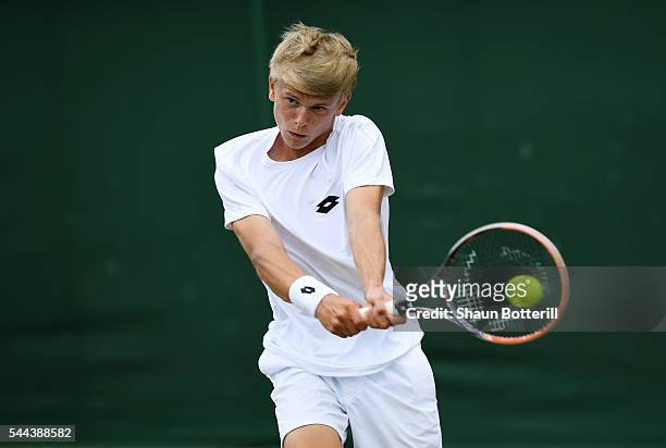 Marvin Moeller of Germany plays a backhand during the Boy's doubles first round match against Finn Bass of Germany on Middle Sunday of the Wimbledon...