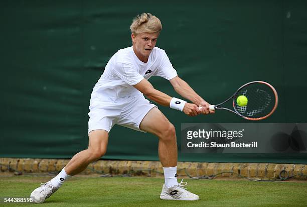 Marvin Moeller of Germany plays a backhand during the Boy's doubles first round match against Finn Bass of Germany on Middle Sunday of the Wimbledon...