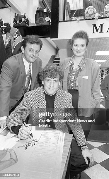 Welsh soccer player Mark Hughes signs an autograph at the Marathon Sports shop , Dublin, Ireland, April 6, 1993.