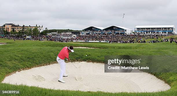 Thongchai Jaidee of Thailand plays his second shot from a bunker on the 18th hole during day four of the 100th Open de France at Le Golf National on...