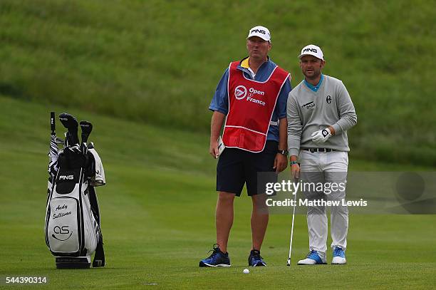 Andy Sullivan of England looks on with his caddie during day four of the 100th Open de France at Le Golf National on July 3, 2016 in Paris, France.