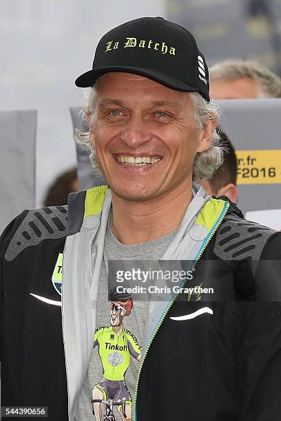 Team owner Oleg Tinkov gestures after Peter Sagan of Slovakia riding for Tinkoff wins stage two and takes the yellow leader's jersey during stage two...
